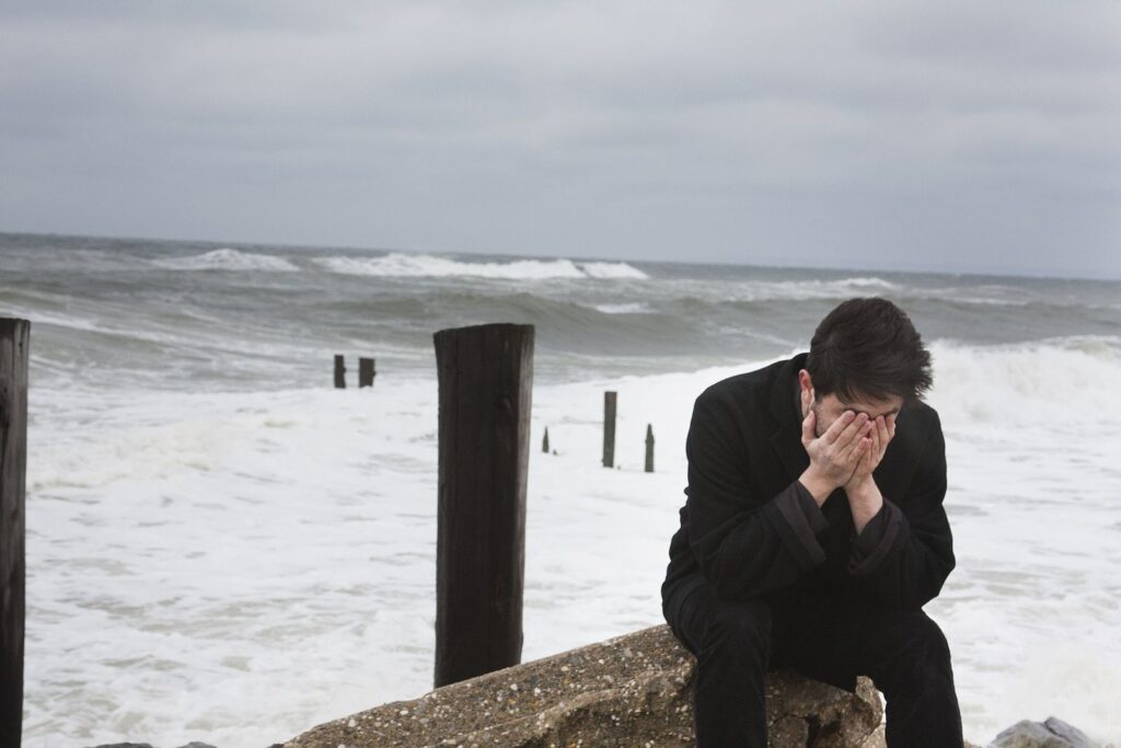 Depression: sad man at beach